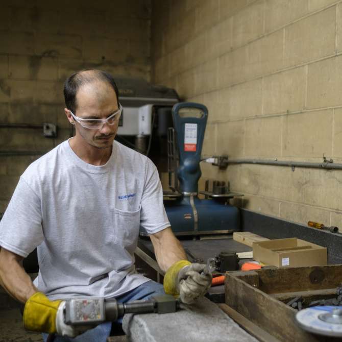 Man in safety gear working on a machine