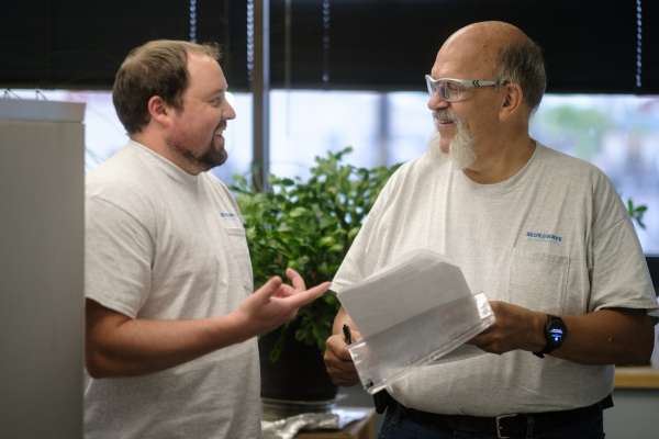 men smiling while talking to each other