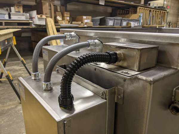 3 hoses connecting industrial machine