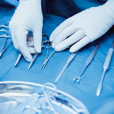 gloved hands sorting surgical tools