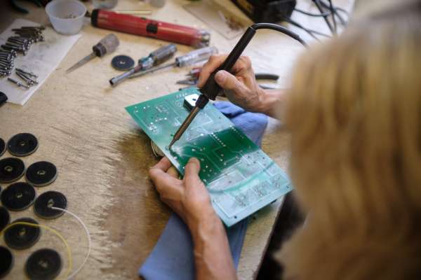 man at computer with blueprint showing