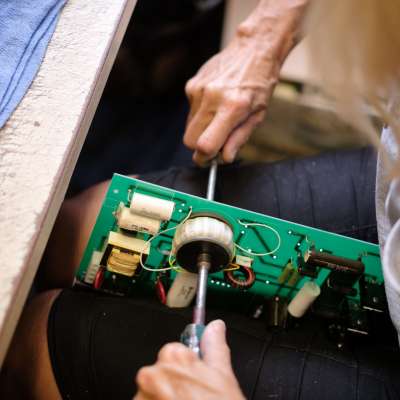 hands working on electrical panel