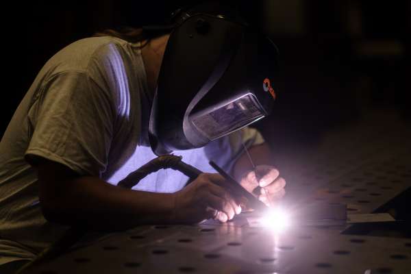 person with mask welding