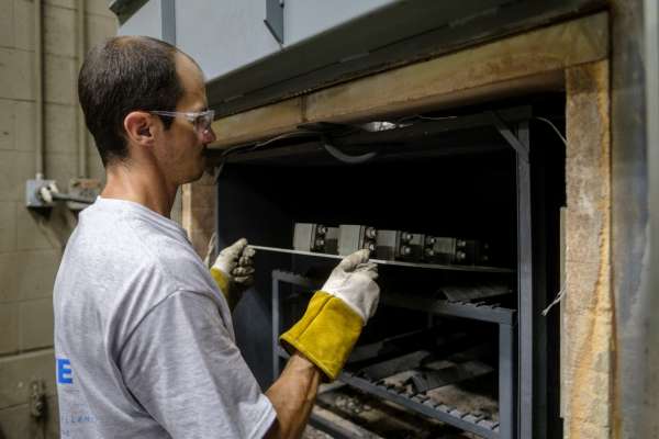 man with protective equipment firing parts