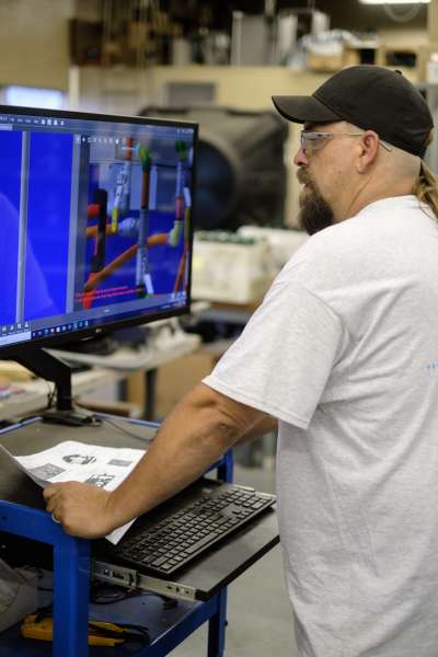 Man at computer with technical data showing