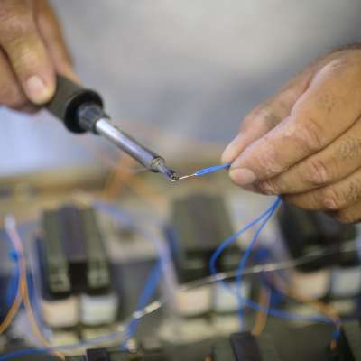 hands soldering wire