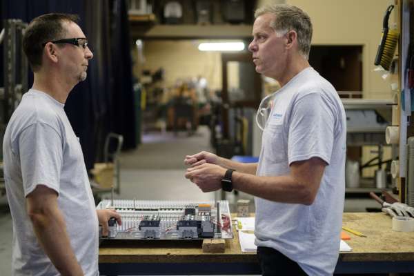 two men with white shirts talking to each other