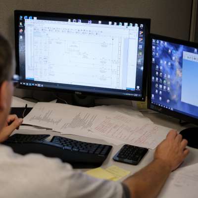 over the shoulder of man working at computer