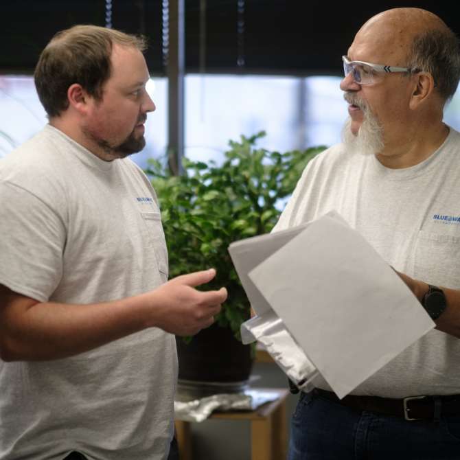 Blue Wave employees discussing a project