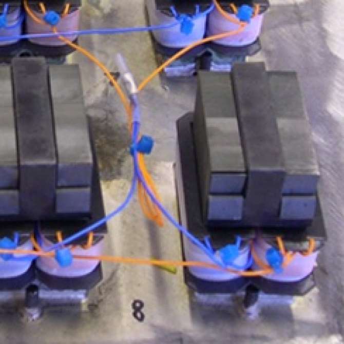 This custom tank under construction features 128 visible magnetostrictive transducers. The tank is over 13 feet long and weighs 1,450 pounds yet the strength of the silver brazening process is on display. The hoist is attacted to only two transducers and l